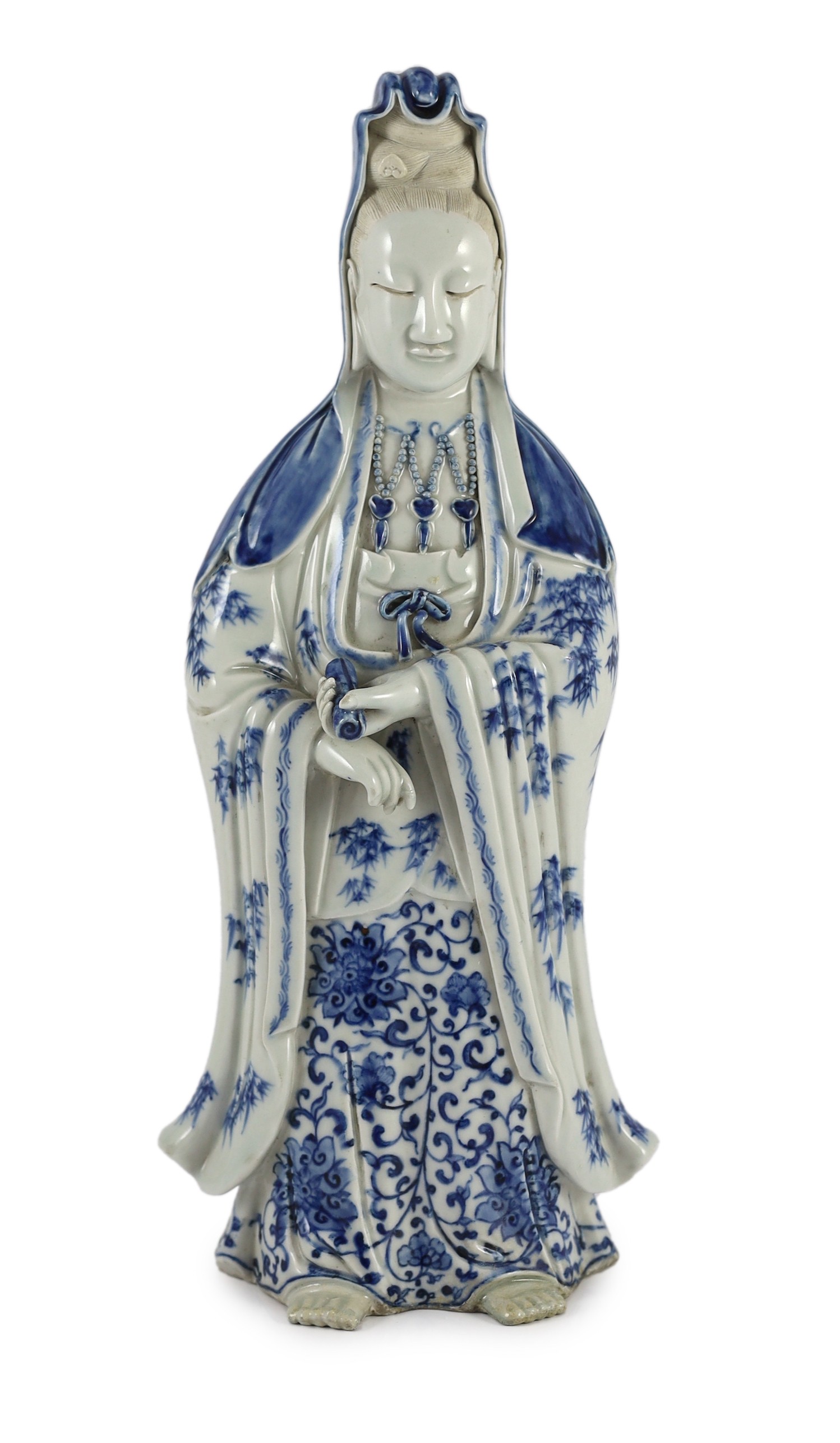 A Chinese blue and white standing figure of Guanyin, late 19th century, 34.5cm high, restoration to left foot